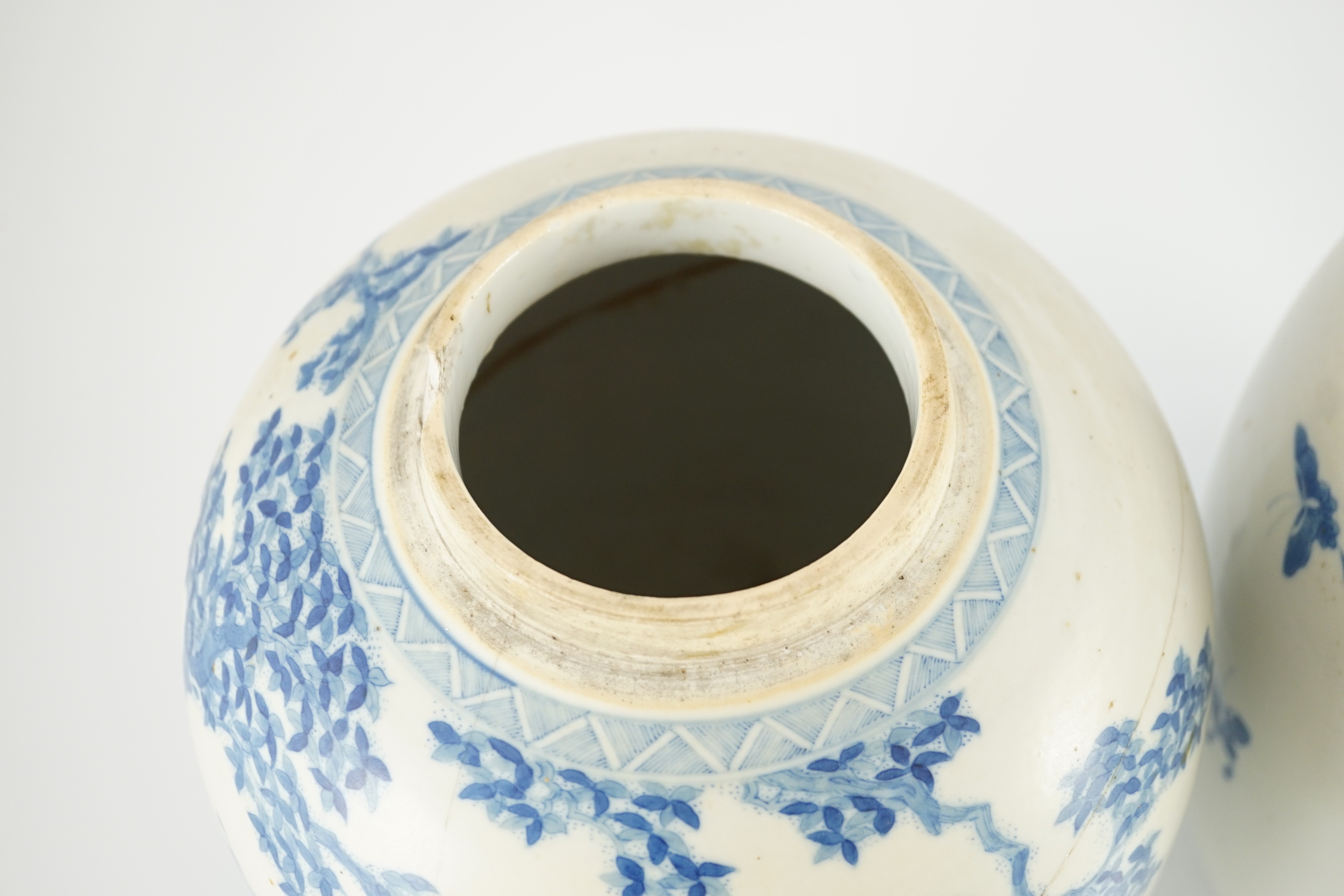 A pair of large Chinese blue and white ovoid jars and associated covers, 19th century, 34.5cm high, damage and repairs